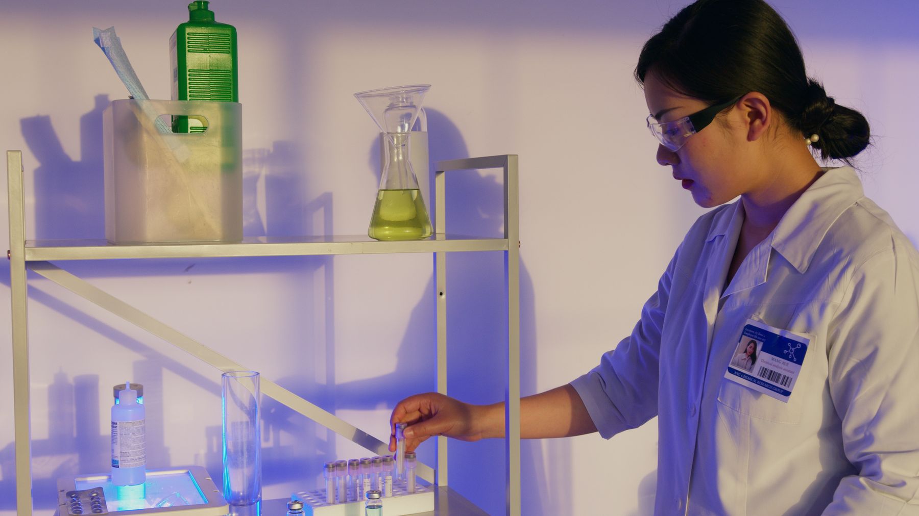 Asian laboratory researcher handling sample vials